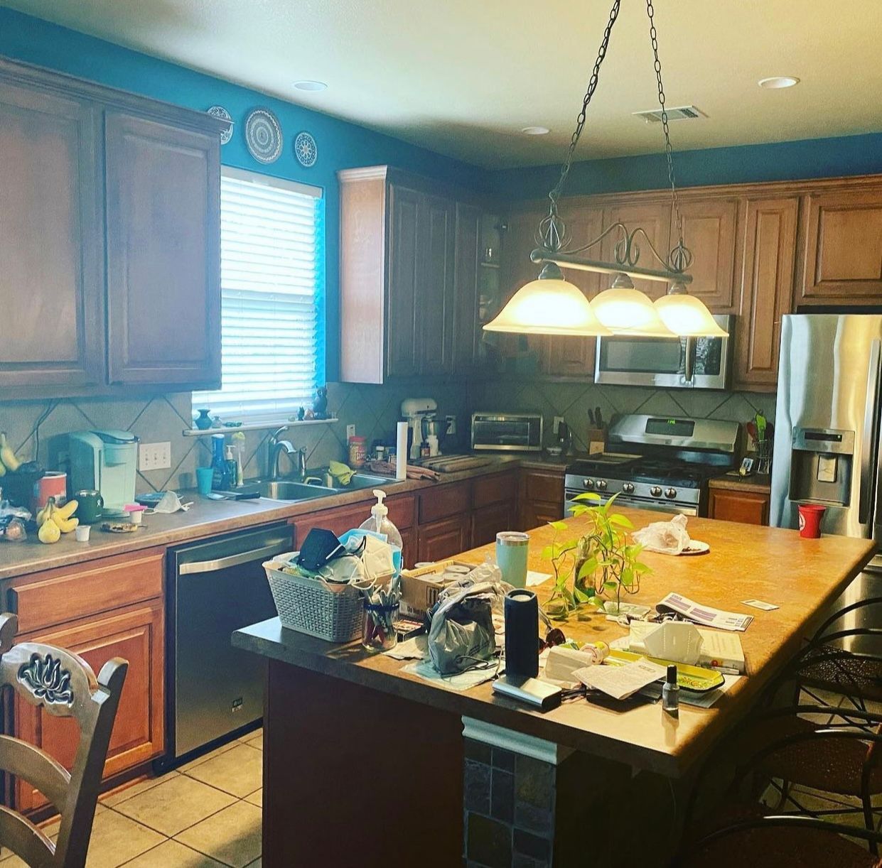 Before photo of Round Rock kitchen remodel with darker cabinets and outdated finishes