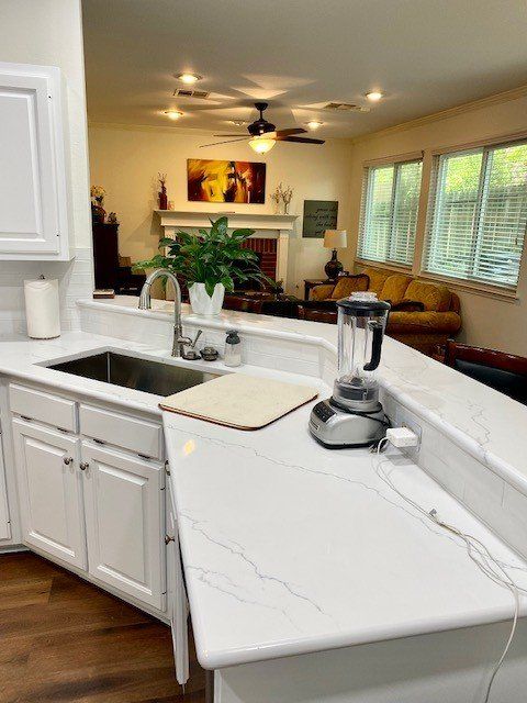 A kitchen with a sink and a blender on the counter