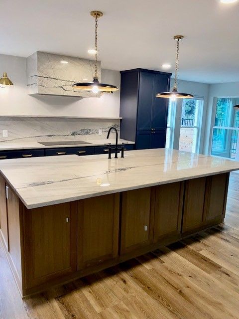 Home in northwest Austin, TX with full kitchen remodel including new cabinets, cabinet painting, cabinet staining, new countertops, and new backsplash completed by Austin Painting and Cabinets