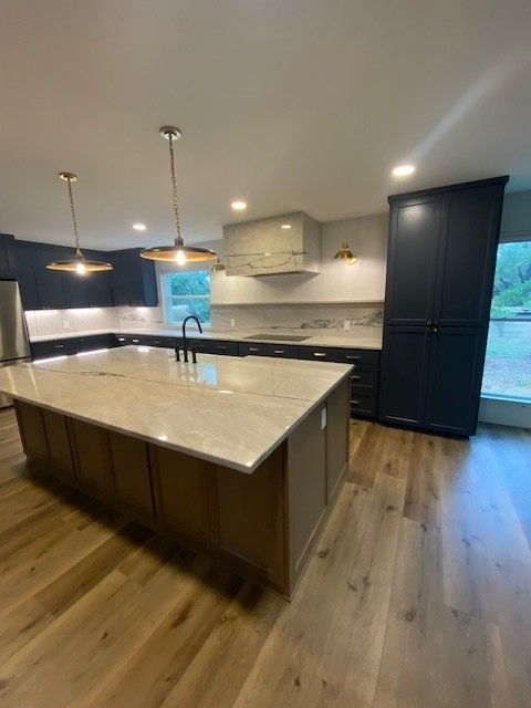 Home in northwest Austin, TX with full kitchen remodel including new cabinets, cabinet painting, cabinet staining, new countertops, and new backsplash completed by Austin Painting and Cabinets