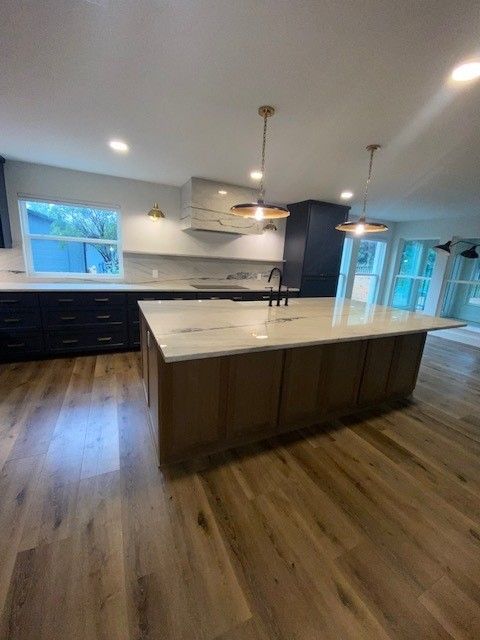 Home in northwest Austin, TX with full kitchen remodel including new cabinets, cabinet painting, cabinet staining, new countertops, and new backsplash completed by Austin Painting and Cabinets
