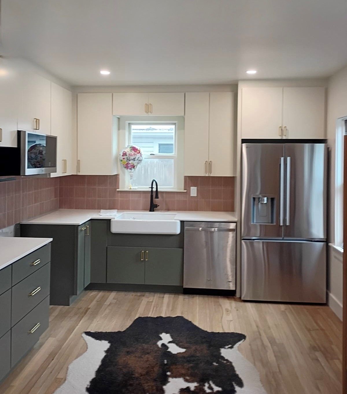 After Central Austin kitchen remodel with new cabinets quartz countertops backsplash and appliances