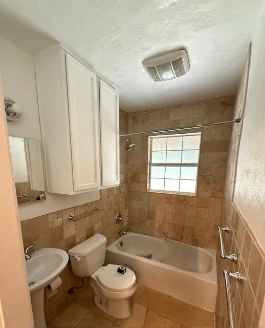 Bathroom before remodel in East Austin showing outdated tub and fixtures