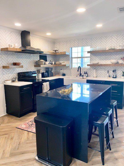 A kitchen with a table and chairs and a clock on the wall