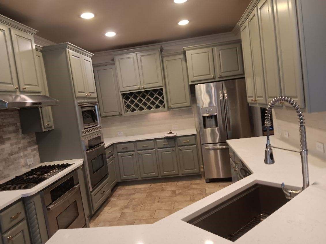 Home in Cedar Park, TX with full kitchen remodel including cabinet painting, new countertops, and new backsplash completed by Austin Painting and Cabinets