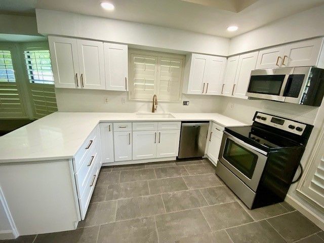 Home in the north Austin, TX with full kitchen remodel including new cabinets, new countertops, new backsplash, and whole house interior painting completed by Austin Painting and Cabinets