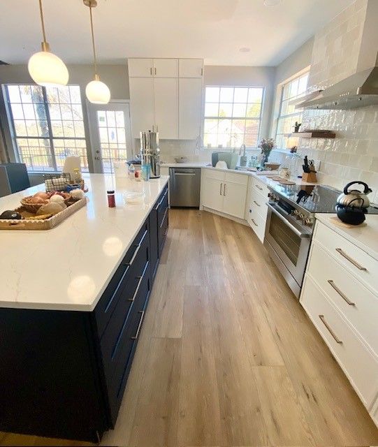 Home in Lakeline area of Austin, TX with full kitchen remodel including new cabinets, cabinet painting, new countertops, and new backsplash completed by Austin Painting and Cabinets