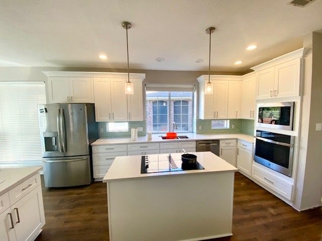 Home in northwest Austin, TX with full kitchen remodel including new cabinets, cabinet painting, new countertops, and new backsplash completed by Austin Painting and Cabinets