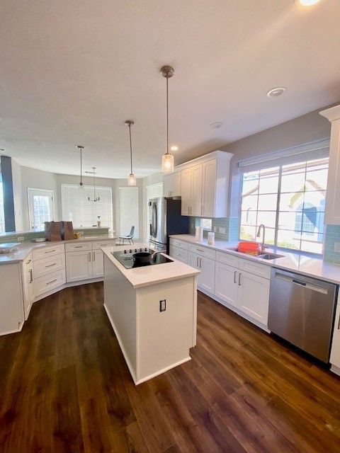 Home in northwest Austin, TX with full kitchen remodel including new cabinets, cabinet painting, new countertops, and new backsplash completed by Austin Painting and Cabinets
