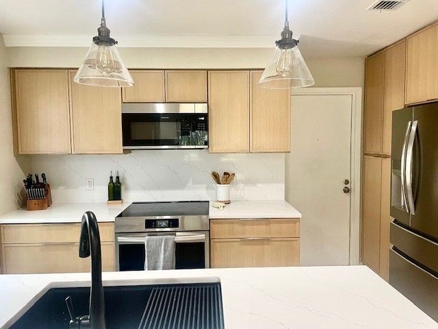 Home in the domain area of north Austin, TX with full kitchen remodel including new cabinets, new countertops, and new backsplash completed by Austin Painting and Cabinets