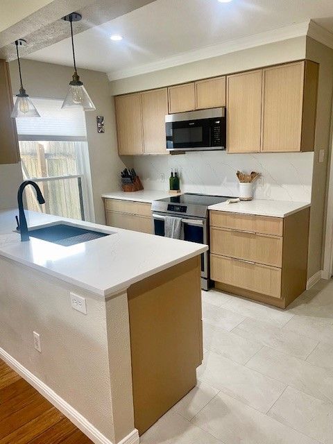 Home in the domain area of north Austin, TX with full kitchen remodel including new cabinets, new countertops, and new backsplash completed by Austin Painting and Cabinets