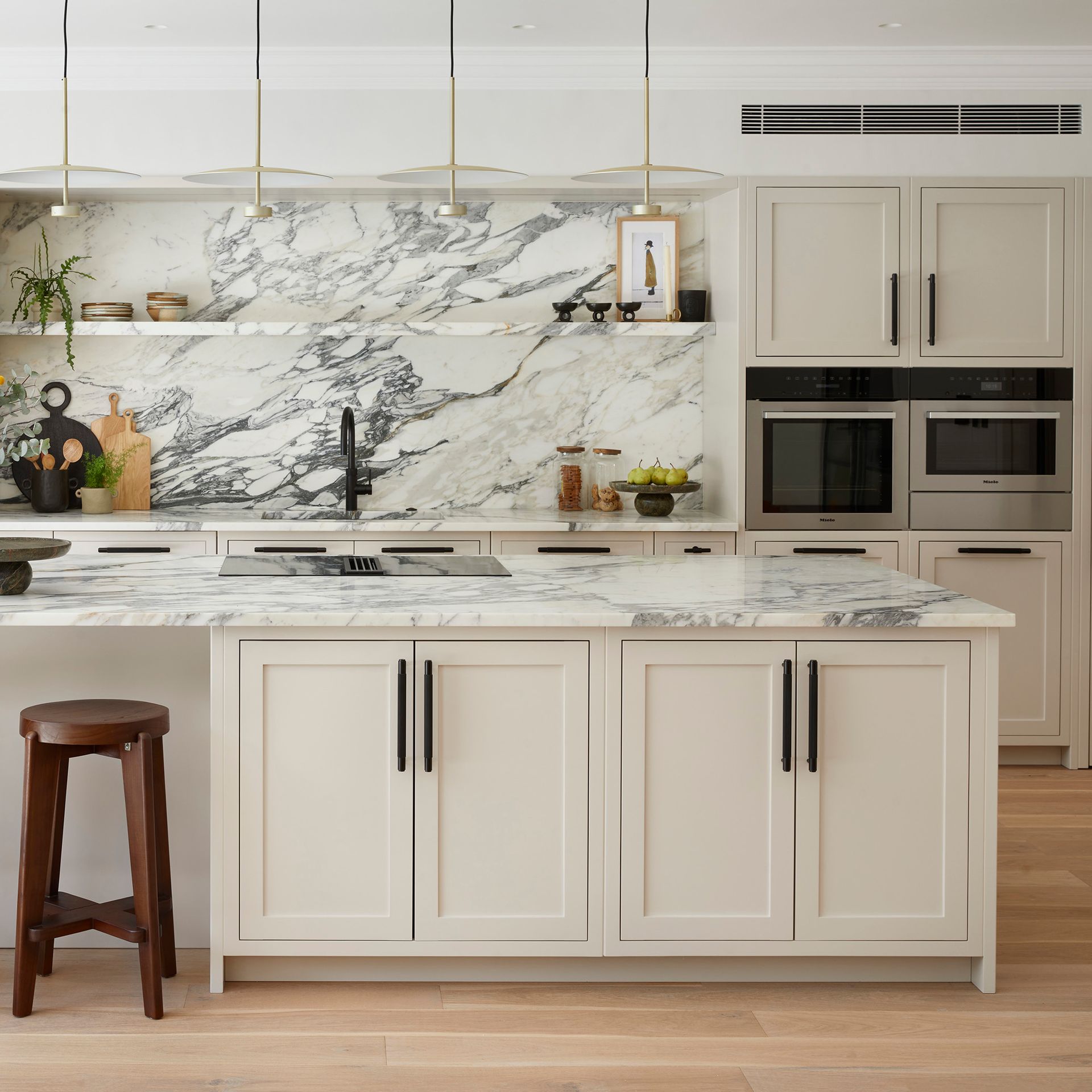 kitchen remodel in Austin with new white shaker cabinets, quartz countertops and backsplash, and mod