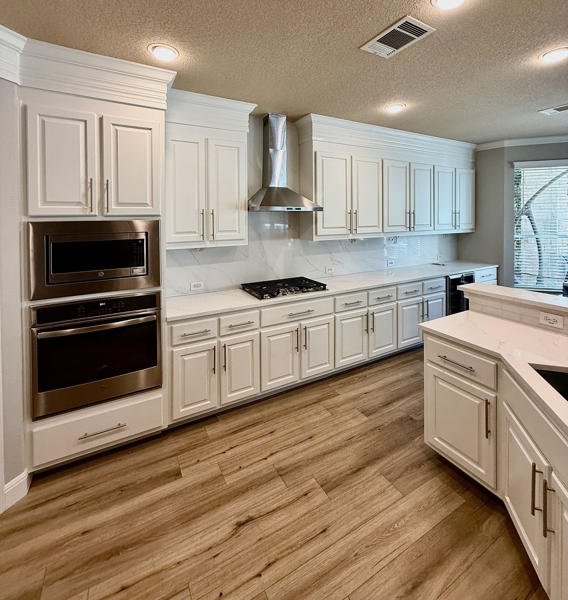 After photo of Avery Ranch kitchen remodel with cabinets to ceiling quartz countertops and backsplas