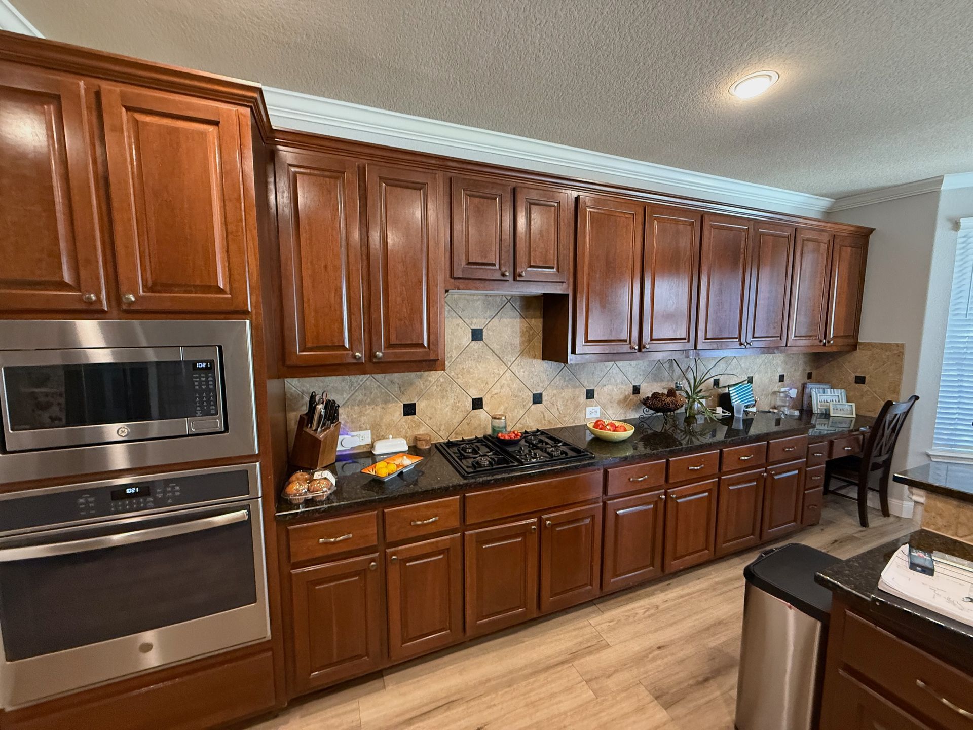 Before photo of Avery Ranch Northwest Austin kitchen remodel with desk area and shorter cabinets