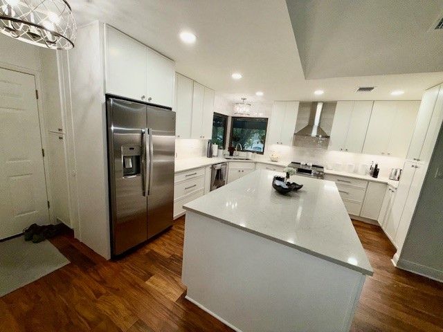 After photo of Northwest Hills Austin kitchen remodel with wall removed new cabinets countertops