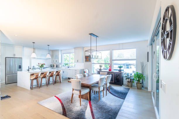 Open-concept kitchen remodel in Austin featuring a large island, quartz countertops, white cabinets 