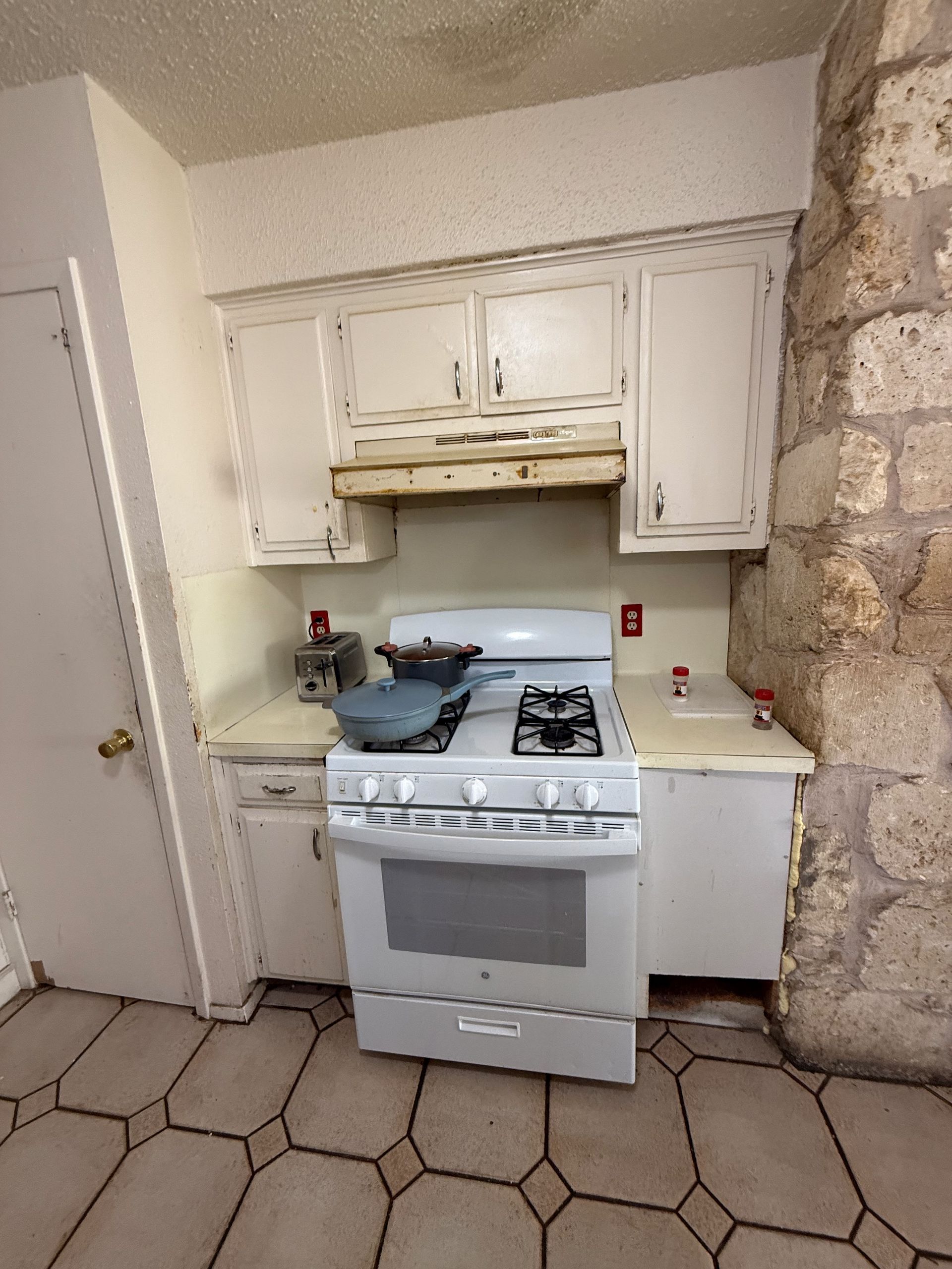 Before South Austin kitchen remodel with outdated cabinets and furdown above cabinets