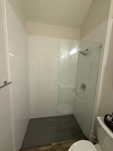 Before photo of West Austin bathroom remodel with older shower finishes