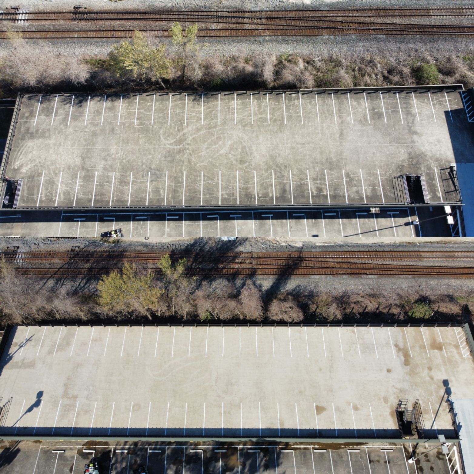 an aerial view of a parking lot next to a train track