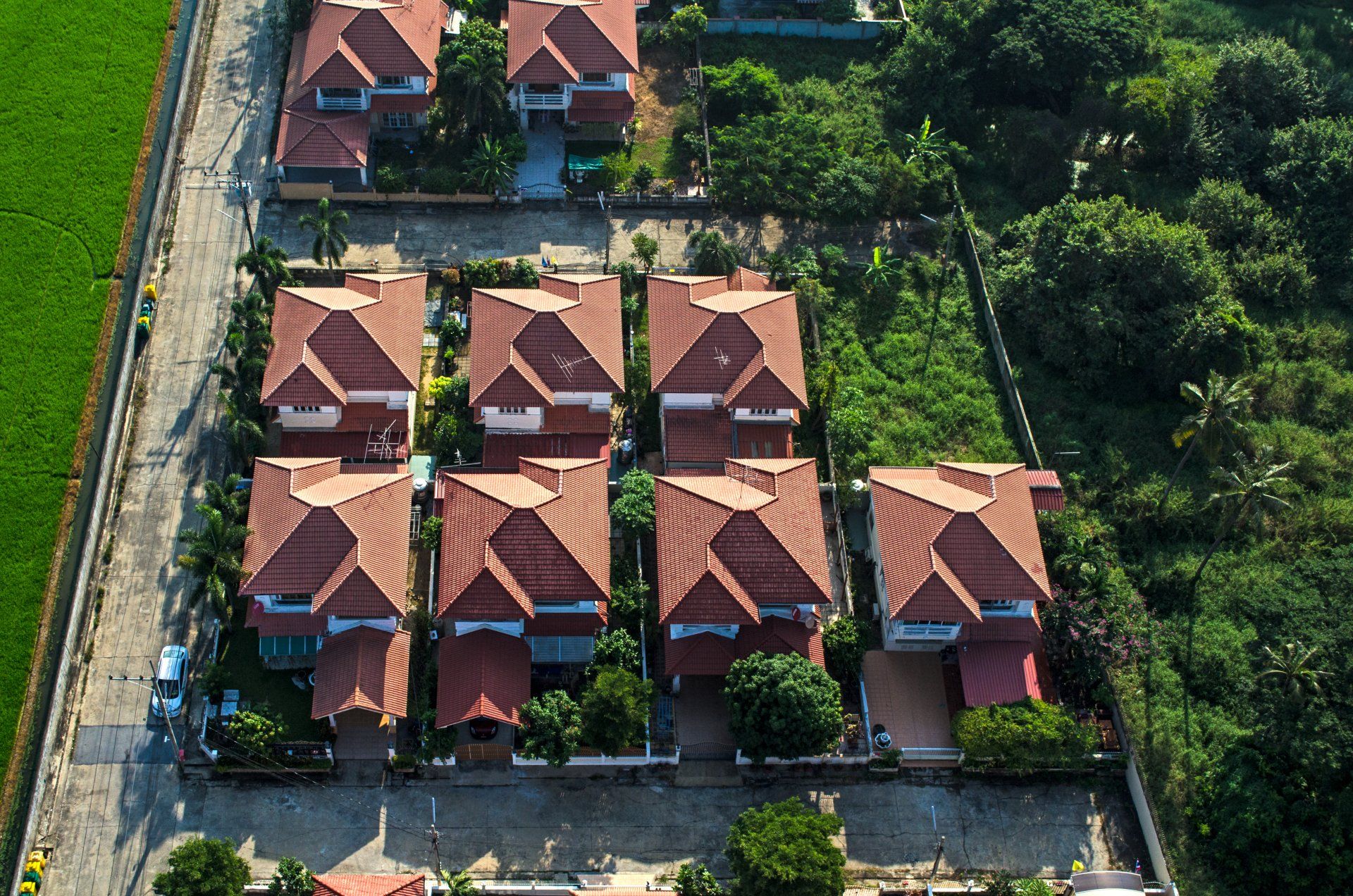 an aerial view of a residential area with red tile roofs