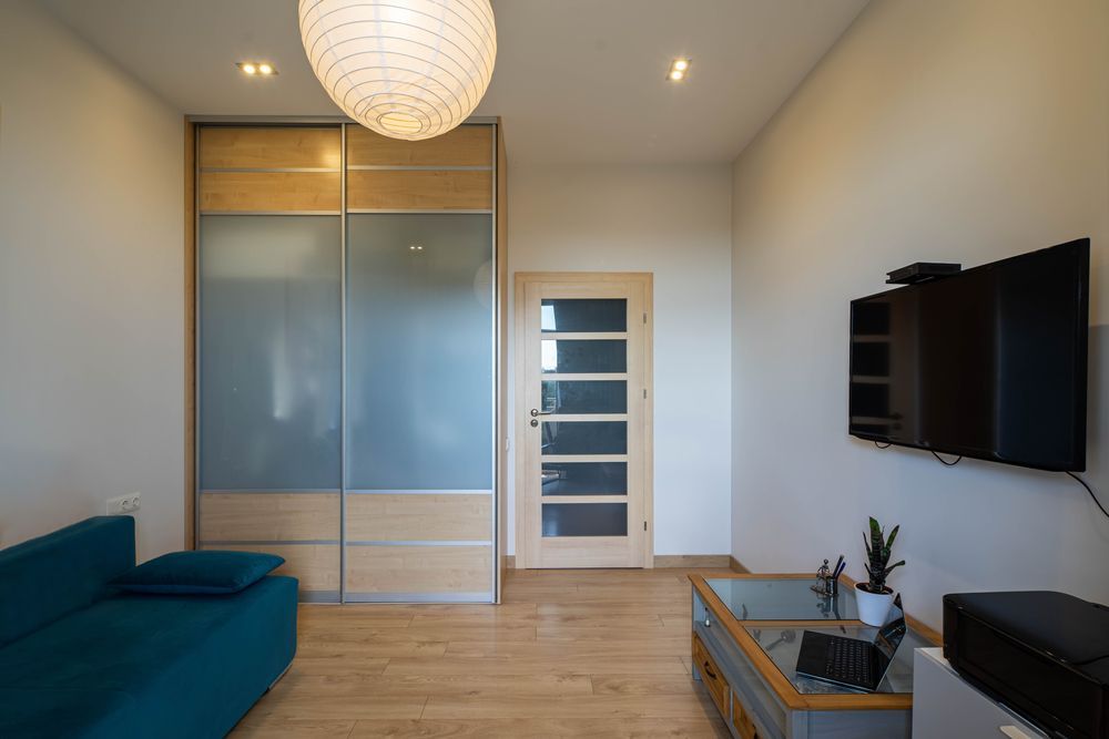 A Living Room With A Couch, Television And A Cabinet — Nobbs & Myers Glass In Mullumbimby, NSW