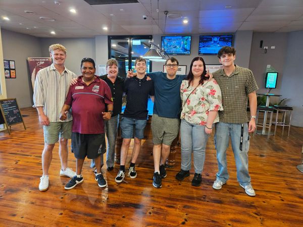 A Group Of People Are Putting Their Hands Together In A Circle — Advanced Therapy Mackay In Mackay, QLD