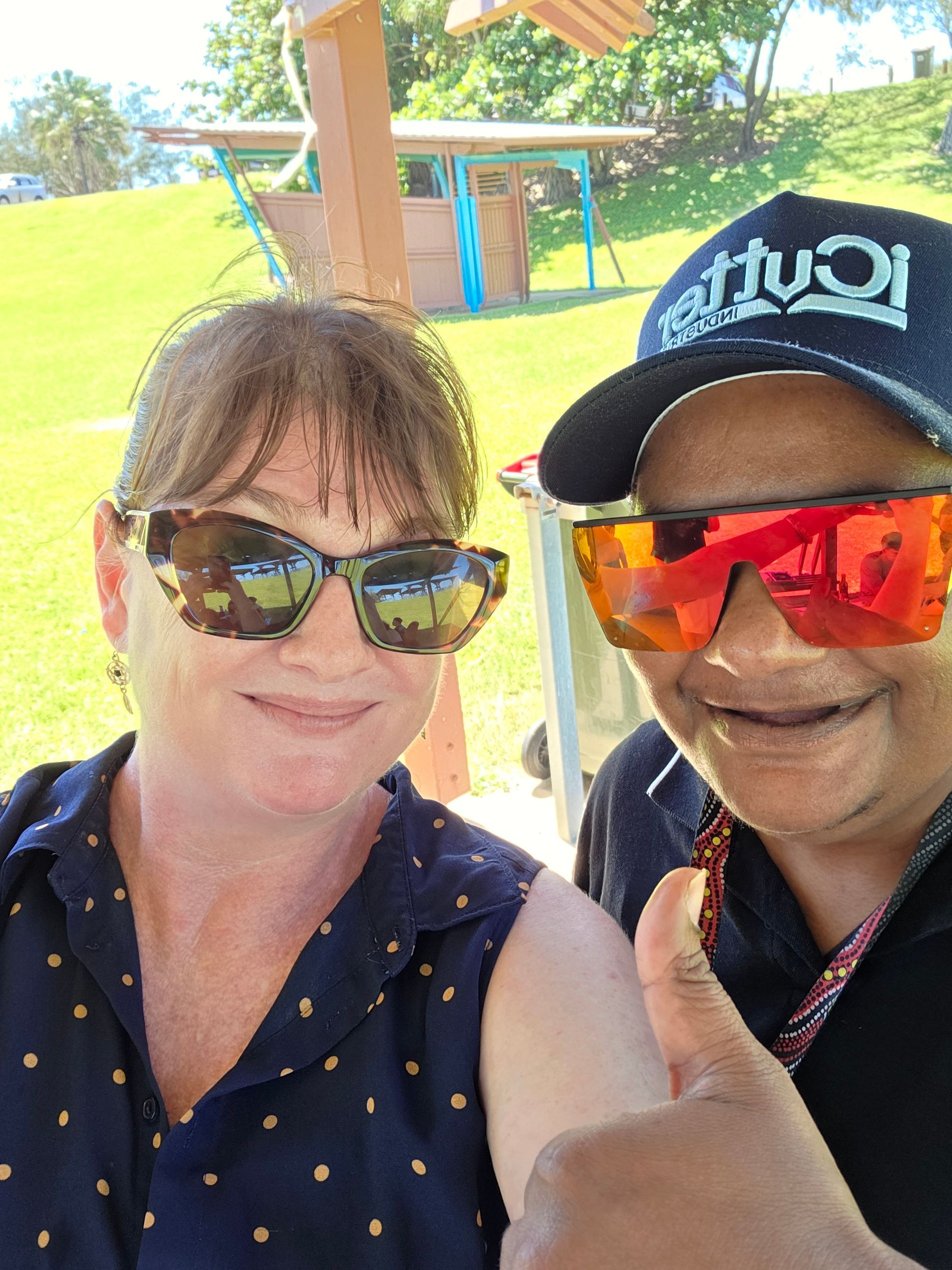 A Group Of People Are Sitting At A Long Table Eating Food — Advanced Therapy Mackay In Mackay, QLD 