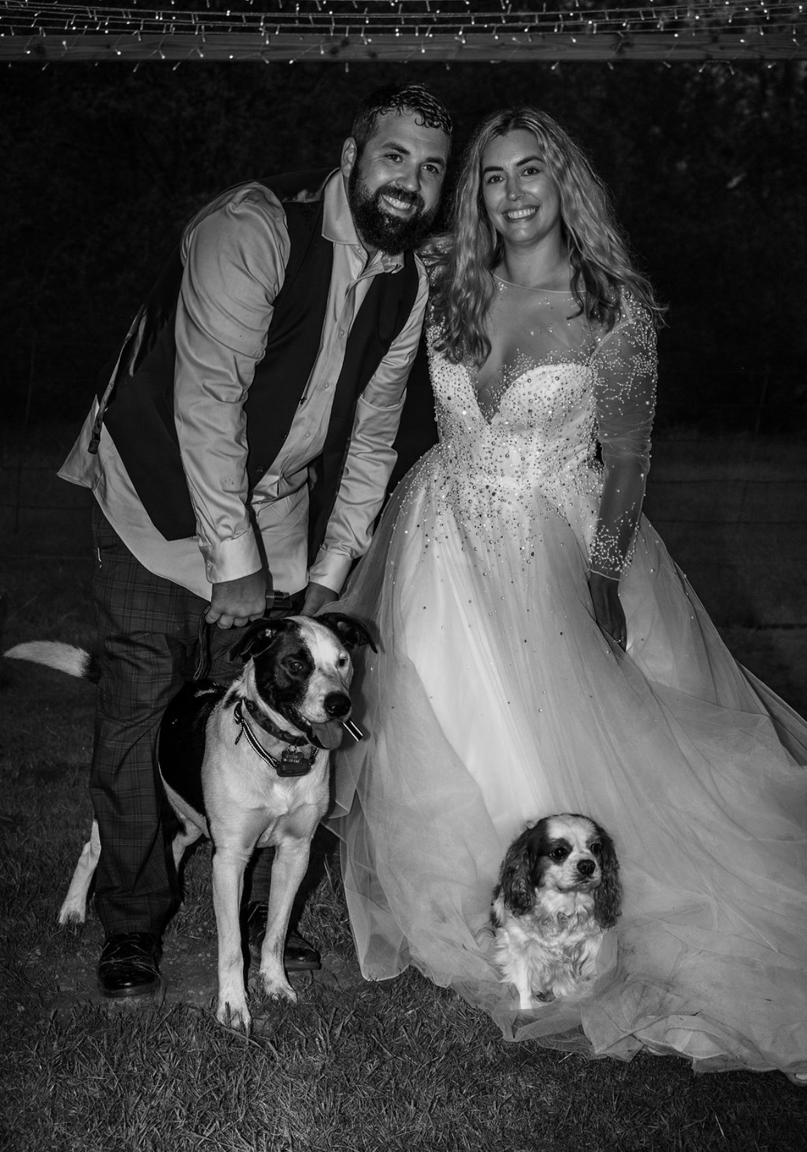 A woman with short white hair and a white shirt is looking at the camera.