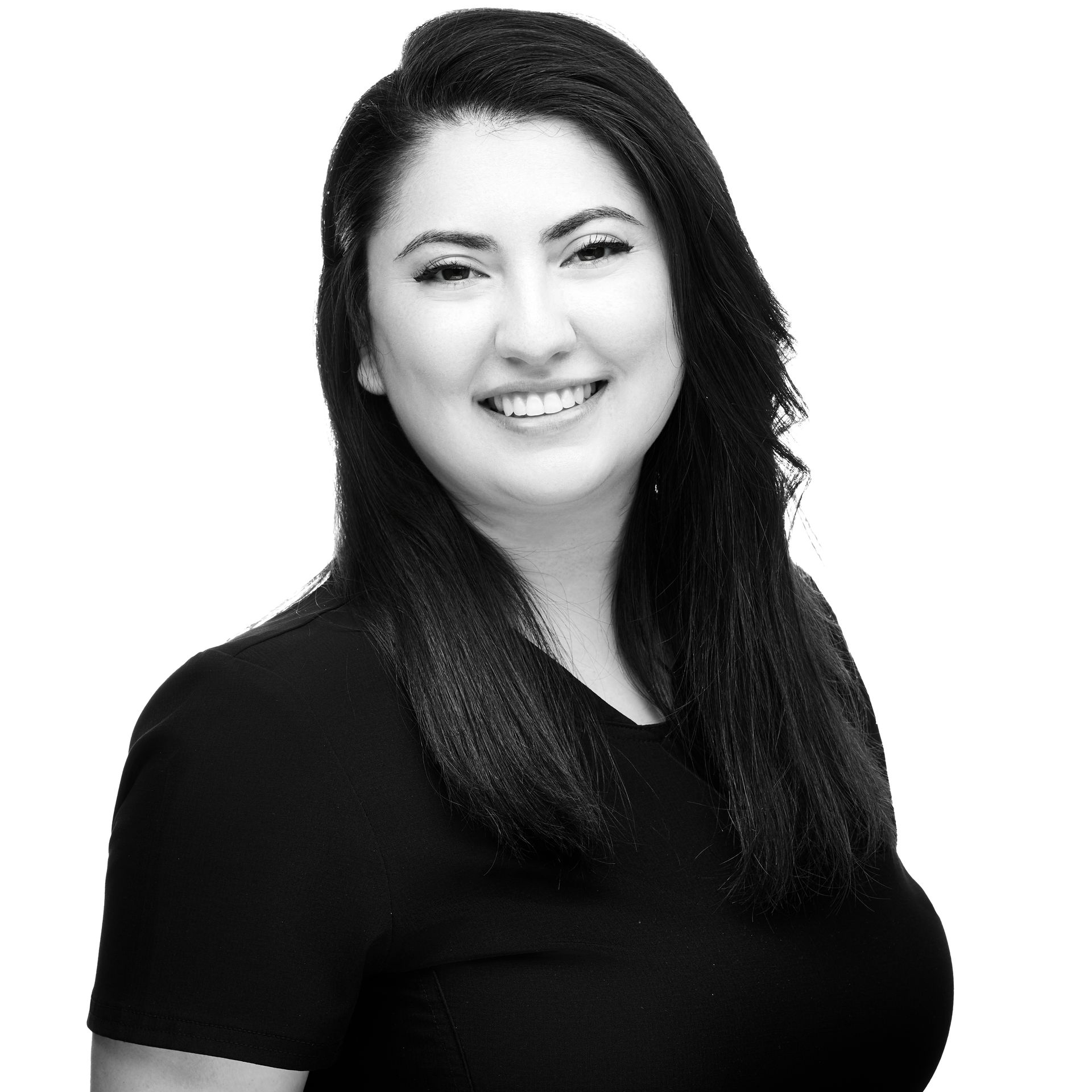 A woman in a black shirt is smiling in a black and white photo