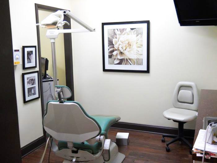 A dental office with a picture of a flower on the wall