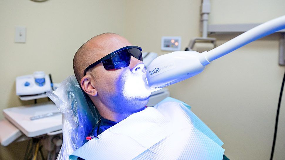 Patient undergoing teeth whitening treatment