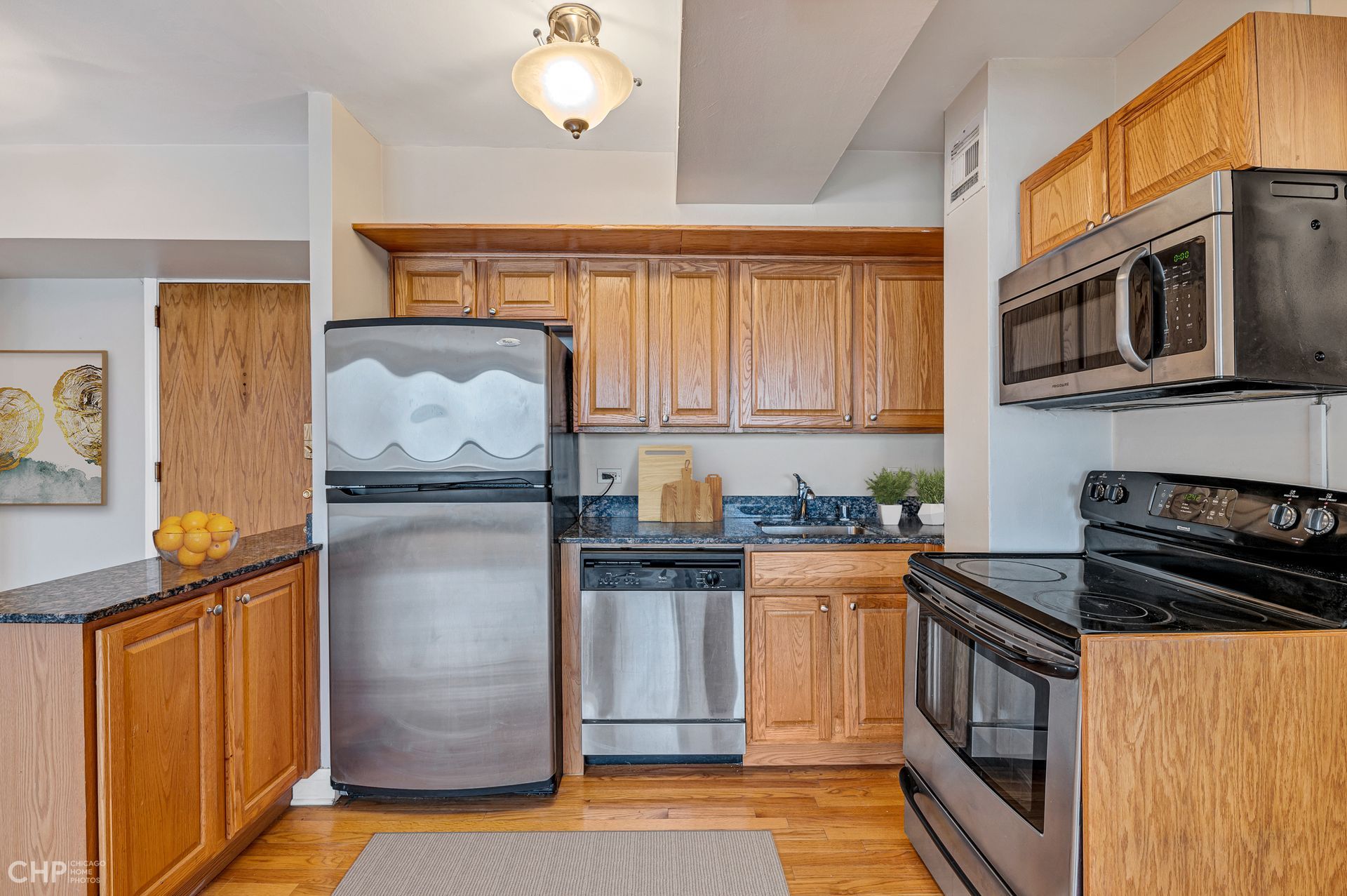 A kitchen with stainless steel appliances and wooden cabinets
