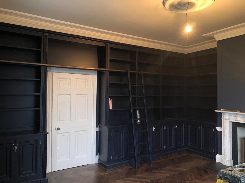 White door accent to charcoal paint library room