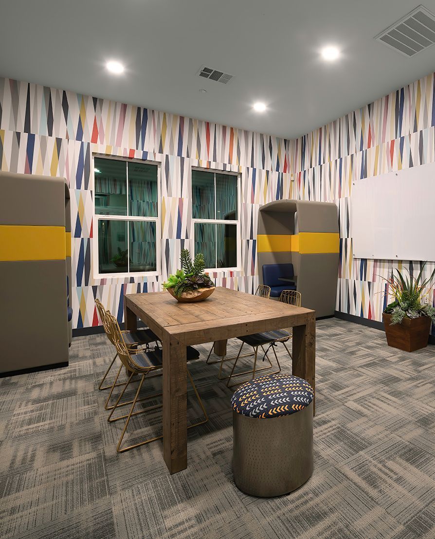A room with a wooden table and chairs in it