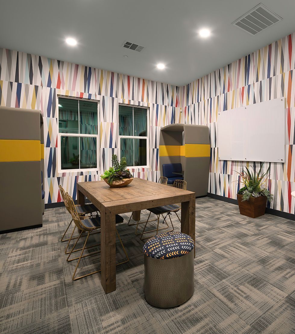 A room with a wooden table and chairs in it