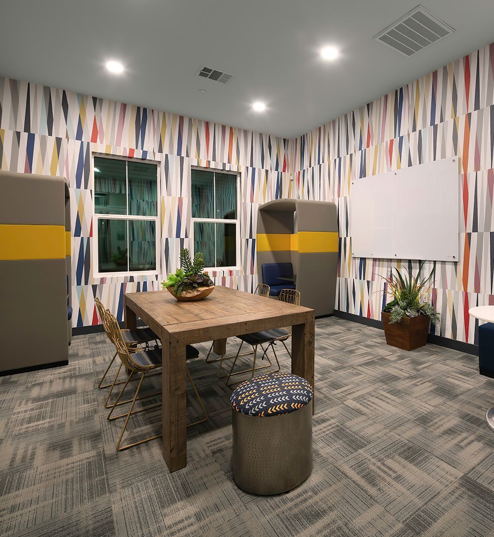 A room with a wooden table and chairs in it