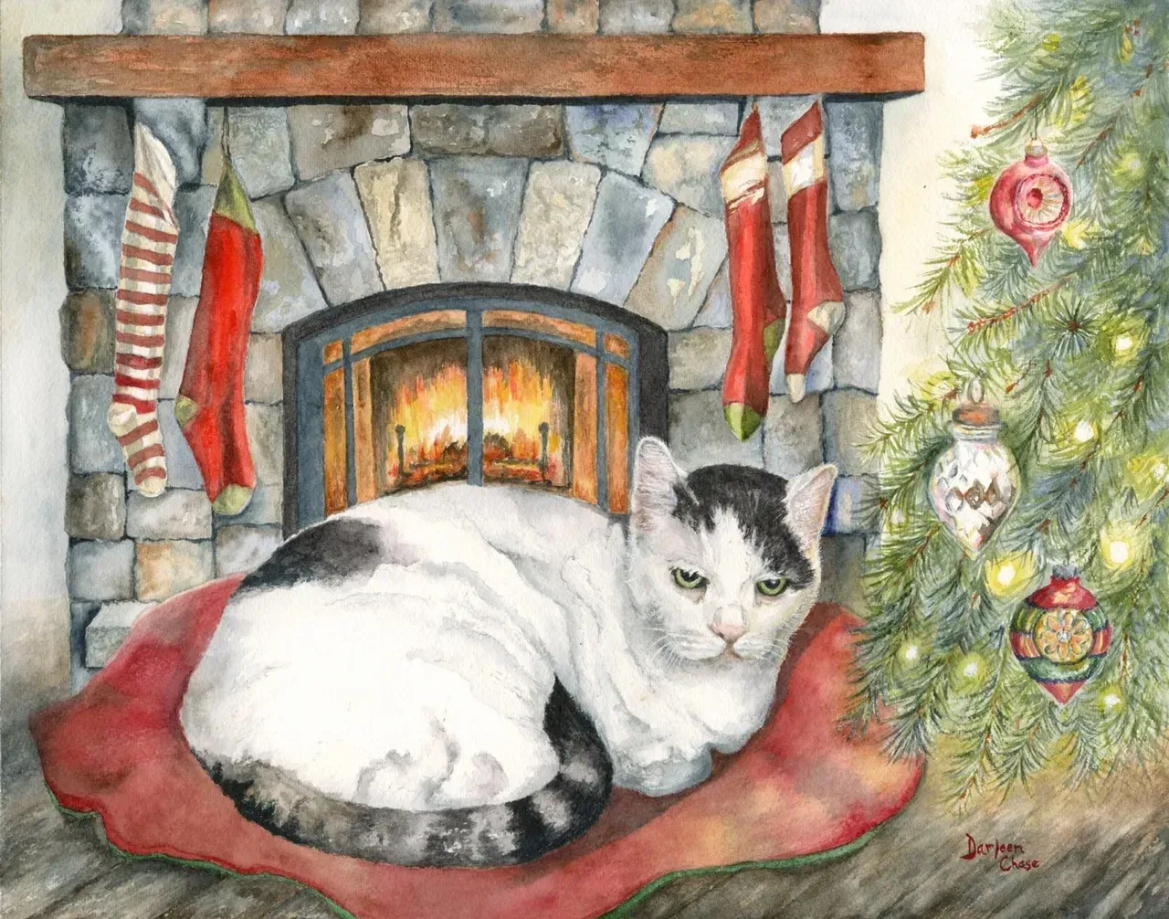 White cat curled on red blanket by a lit stone fireplace with Christmas decorations and tree