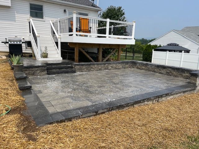 Patio With A Deck And Stairs In Front Of A House — Enola, PA — J & C Landscaping