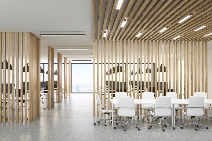 A modern office with wooden dividers and tables and chairs.