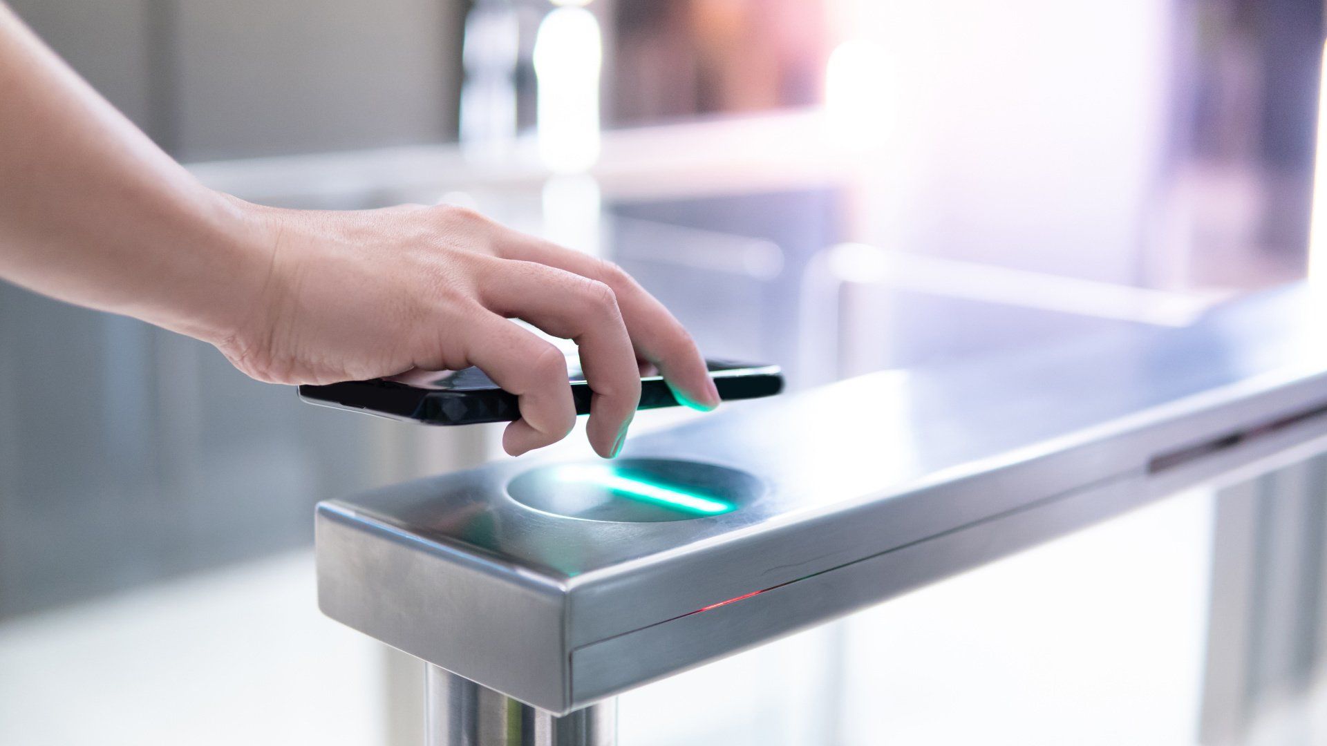A person is using a cell phone to open a gate.