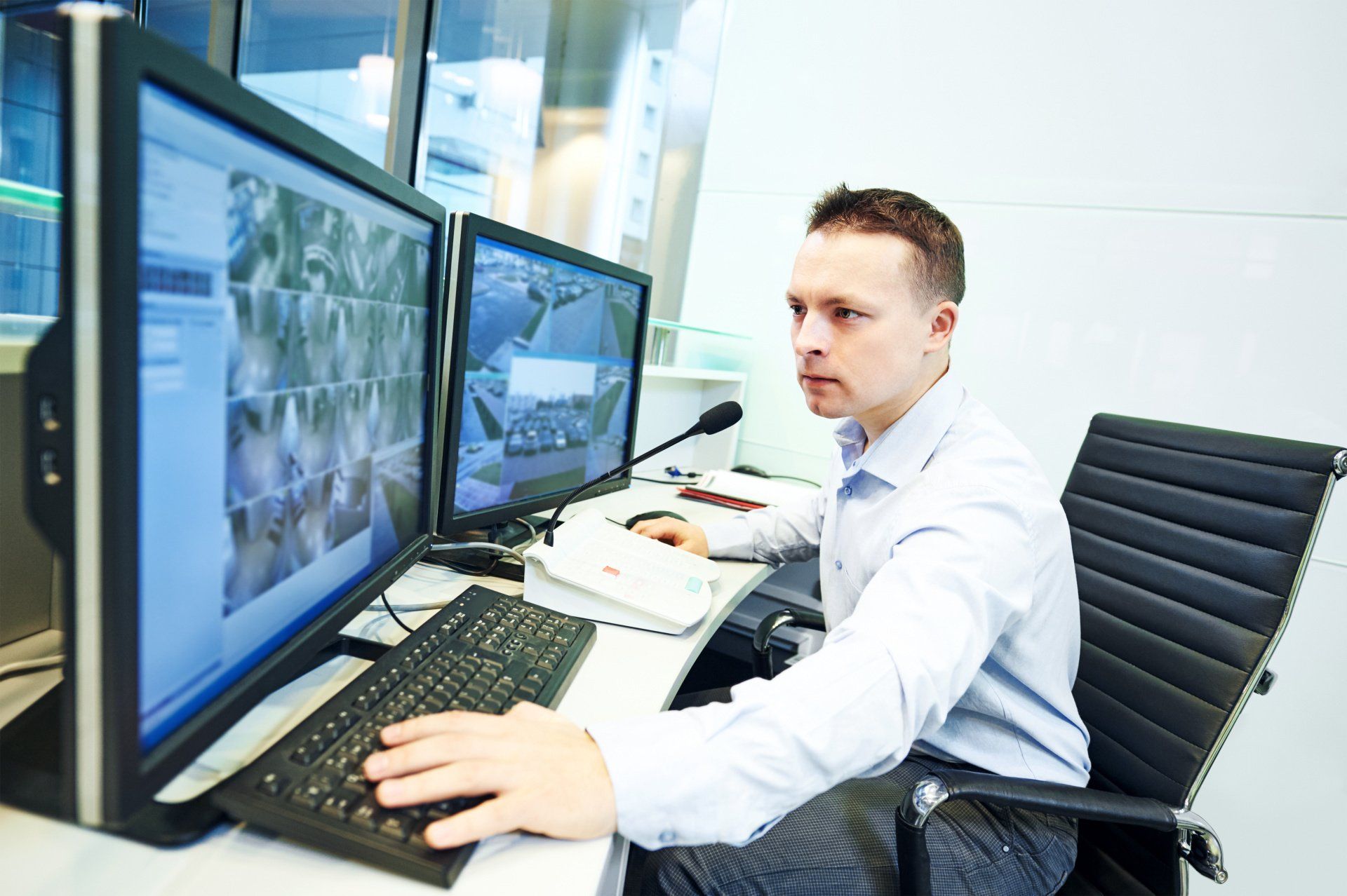 A man is sitting at a desk using a computer.