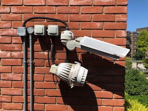 A brick wall with a camera mounted on it