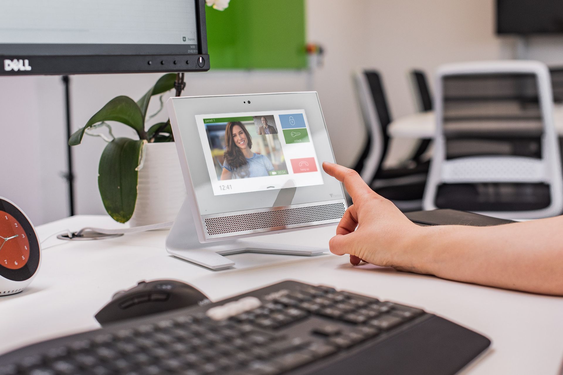 A person is sitting at a desk using a tablet computer.