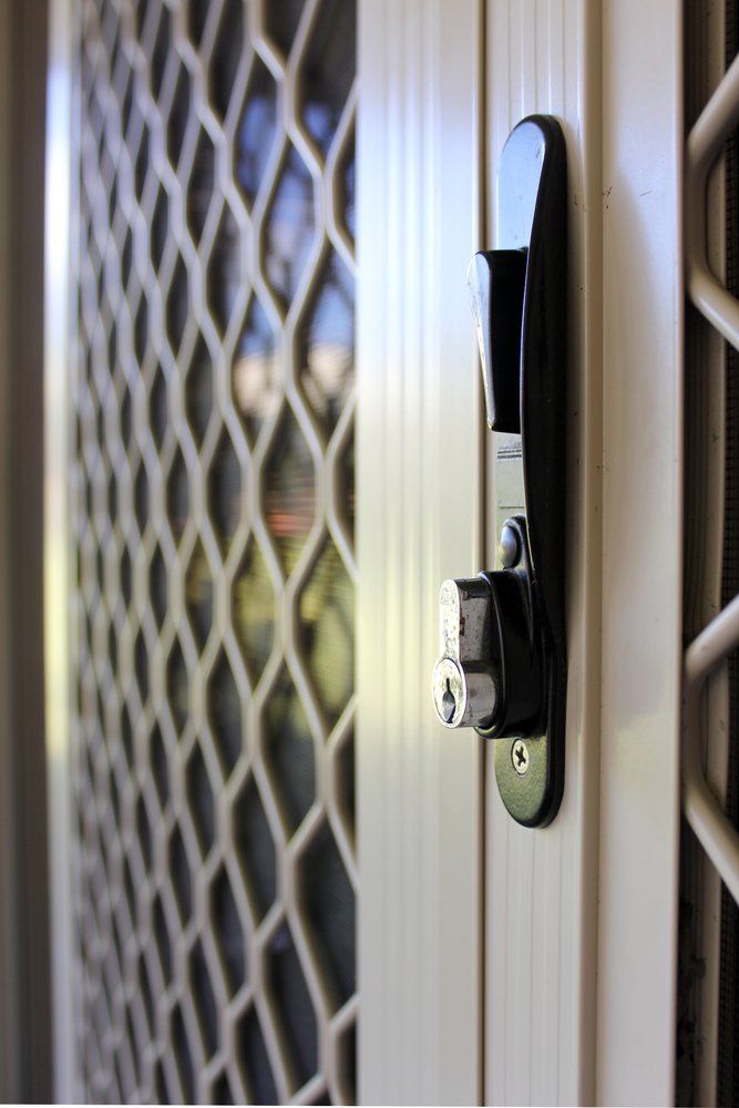 Close-up Of A Door Lock On A White Diamond Screen Door — Coastal Screens & Glass in Port Macquarie, NSW