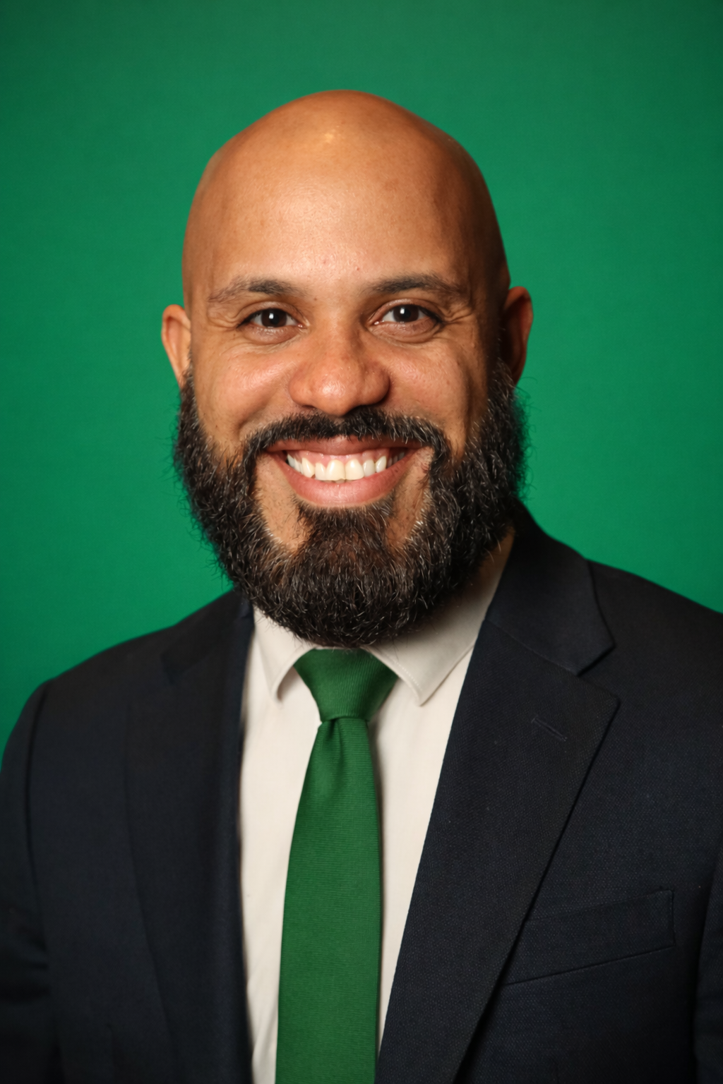 An elderly man and a nurse are looking out of a window.