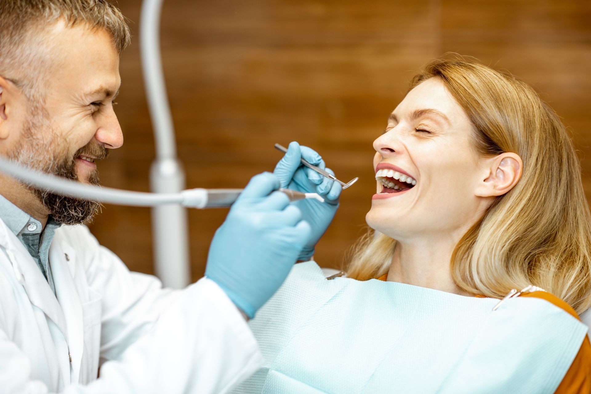 adult patient laughing with dentist