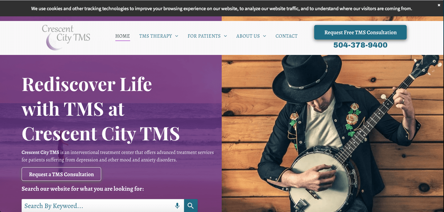 A man in a hat is playing a banjo on a website.