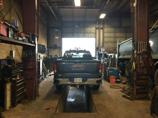 A gmc truck is parked in a garage.