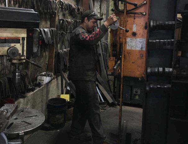 A man is working on a machine in a garage.