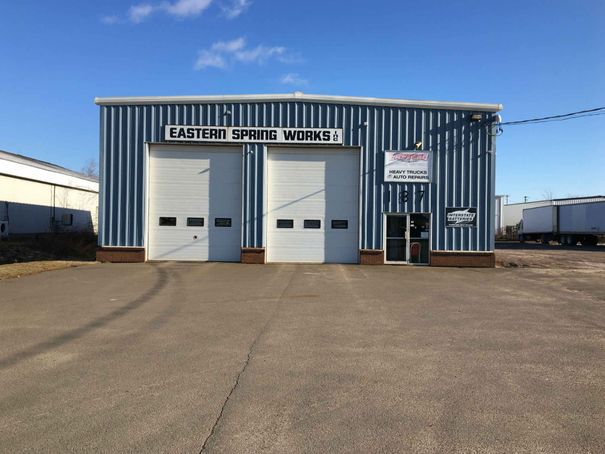 A blue and white building with a sign that says eastern spring works